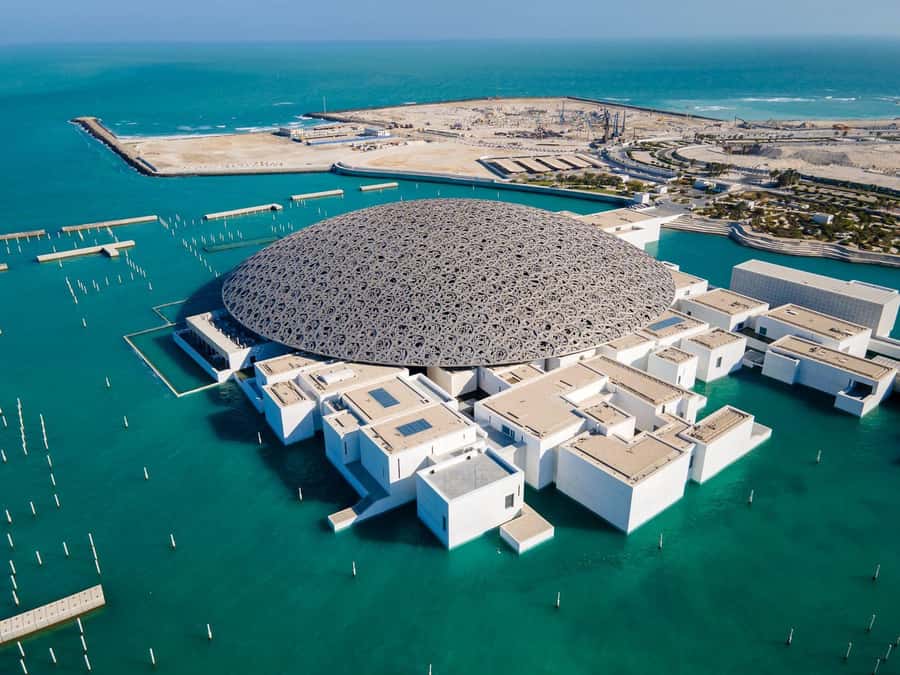 From Abu Dhabi: City Tour with Grand Mosque & Louvre Museum - Hotel pickup and the ride across Abu Dhabi